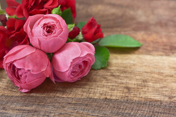 Pink roses on a wooden table