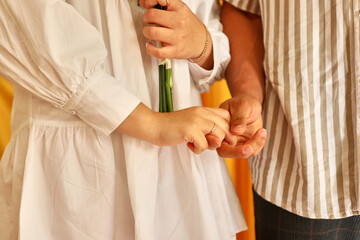 The bride and groom stand next to each other, holding hands. Wedding ceremony.