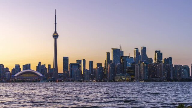 Toronto City downtown skyline panorama horizon at sunset time. Ontario, Canada. Time-lapse photography dusk to night.