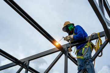 Asian construction worker believes steel structure in industrial building construction site