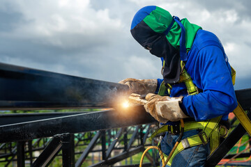 Asian construction worker believes steel structure in industrial building construction site