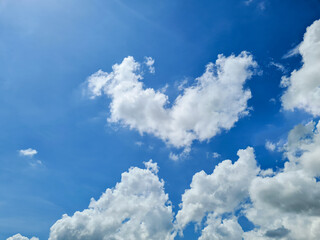 Fototapeta na wymiar Heart shaped cloud on bright blue sky.
