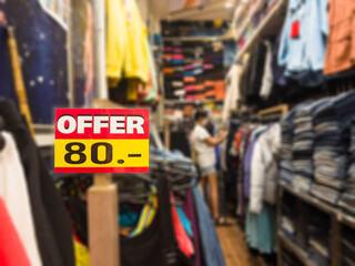 "Offer 80 THB" sign clothing store with blurred effect, at Thailand.