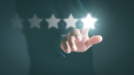 Businessman pointed out the five-star review rating, satisfaction rating,customer services best excellent business rating experience,positive feedback, excellent star achievement evaluation