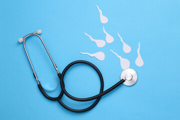 Male sexual health. Analysis of the causes of infertility. Stethoscope with male semen(spermatozoa) on a blue background