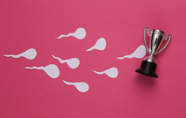 Competing spermatozoa and goblet on pink background. Conception, ovulation concept