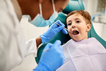Little boy during teeth check up at dentist's office.
