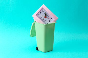 Deadline. Trash can with a clock on a turquoise background
