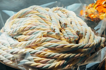 A bunch of cute pastel coloured braided marshmallows  from a sweets shop.