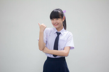 Portrait of thai Junior high school student uniform beautiful girl pointing