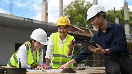 Team of specialists and Civil engineer inspecting industrial building construction site