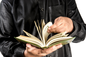 Koran in hand - holy book of Muslims ( public item of all muslims )