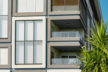 Image of the exterior of a residential building against a blue sky.