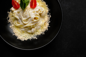 Pappardelle with cheese, sauce and tomatoes. horizontal