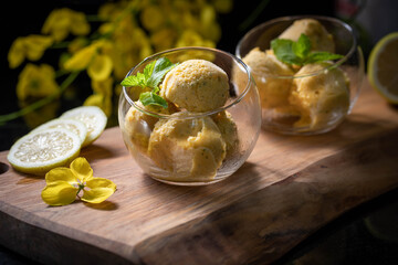 Mango ice cream. Mango ice cream balls in a transparent glass garnished with mint leaves.
