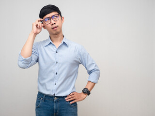 Young asian man feels serious hold his glasses isolated