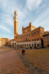 Fototapeta premium The high tower of Torre del Mangia in Piazza del Campo. Siena. Italy