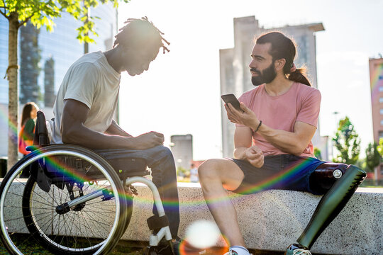 Multiethnic Guys With Disability Meeting First Time And Having Conversation Through A Online Translator