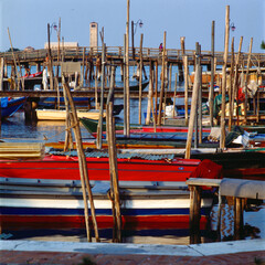 Burano, Venezia. Darsena con barche al Ponte lungo verso Torre e basilica di Torcello