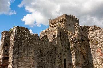 Fototapeta na wymiar The Norman Keep of Portchester Castle and the walls of the Inner Bailey, Portchester, Hampshire, UK, from the outer Bailey. It is now a Scheduled Ancient Monument, freely open to the public