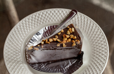 Chocolate Cake with Peanut Topping Wrap in plastic and foil and place on a white plate.