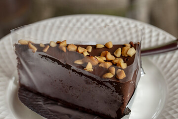 Chocolate Cake with Peanut Topping Wrap in plastic and foil and place on a white plate.