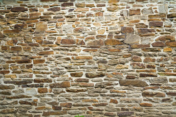 Old stone wall of a building. Stone wall as background or rustic pattern for wallpaper.
