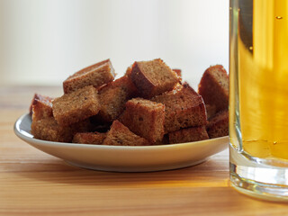 Light beer with salty croutons on a light background