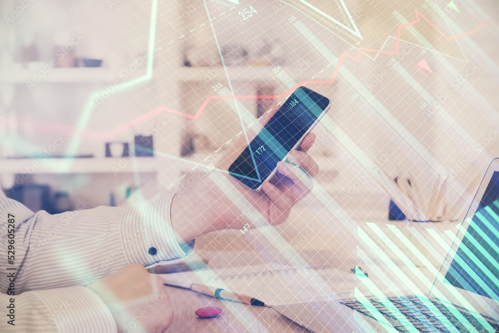 Poster double exposure of man's hands holding and using a digital device and forex graph drawing. financial