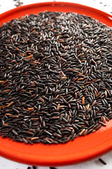 Black rice, also known as purple rice or forbidden rice. Organic unpolished black rice grains as a source of complex carbohydrates and high in antioxidants.  