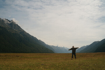 Fototapeta premium Hipster man running and jumping in the mountains