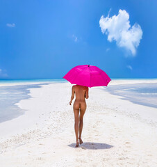 Sexy nude body woman on paradise tropical beach having fun on Maldives. Beautiful naked female model is holding pink umbrella and is walking on the sandy beach. Sexy buttocks girl on a paradise beach. © marcink3333