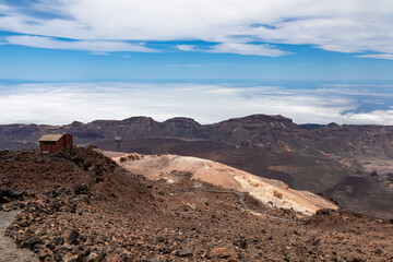Altavista Mountain Refuge near summit of volcano Pico del Teide, Tenerife, Canary Islands, Spain, Europe. Panoramic view on barren landscape, solidified lava, ash, pumice. Lift station next to the hut