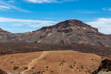 Panoramic view on Guajara, Roque de la Grieta and Montana Majua in volcano Mount El Teide National Park, Tenerife, Canary Islands, Spain, Europe. Volcanic barren desert landscape. Scenic hike trail