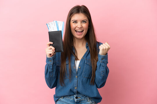 Young caucasian woman isolated on pink background happy in vacation with passport and plane tickets