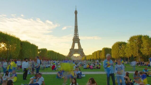 Eiffel tower, Paris, France, timelapse. Champ de Mars and the Eiffel Tower timelapse in a sunny summer day. Paris, France