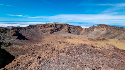 Panoramic view from the summit of Pico Viejo into the active crater. Volcanic barren desert terrain near Pico del Teide, Tenerife, Canary Islands, Spain, Europe. Solidified lava, ash, pumice on path