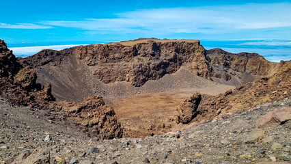 Panoramic view from the summit of Pico Viejo into the active crater. Volcanic barren desert terrain near Pico del Teide, Tenerife, Canary Islands, Spain, Europe. Solidified lava, ash, pumice on path