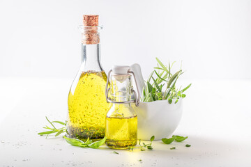 Healthy and fresh oil in bottle with herbs.