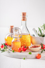 Tasty and healthy oil in bottle with dried tomatoes.