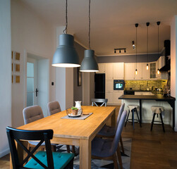 Beautiful luxurious modern dining room and kitchen in brown, yellow and white colors