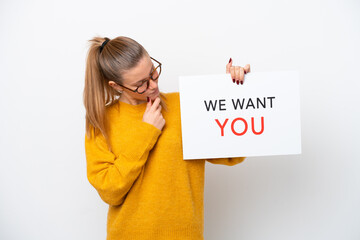 Young caucasian woman isolated on white background holding We Want You board with happy expression