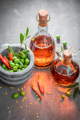 Healthy and tasty oil in bottle with chilli peppers.