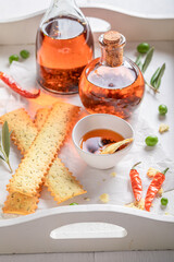 Homemade and fresh breadsticks served with peppers and oil.