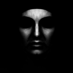 Beauty and fashion concept. Abstract woman face silhouette hiding in shadow. Black and white image. Horror, sci-fi and futuristic looking style. Abstract studio portrait with copy space