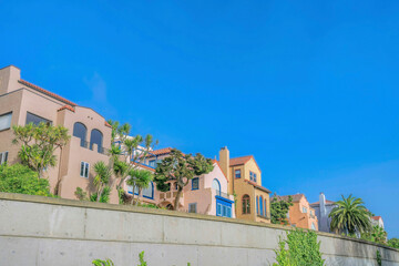 Fototapeta na wymiar Houses with fence against cloudless blue sky in San Francisco California
