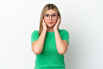 Fototapeta premium Young caucasian woman isolated on white background frustrated and covering ears