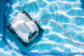 pool cleaning robot Pool maintenance with automatic robot. Cleaning the bottom of the pool and...