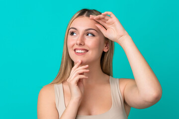 Young caucasian woman isolated on blue background . Portrait