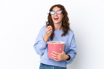 Young woman with curly hair isolated on white background with 3d glasses and holding a big bucket of popcorns